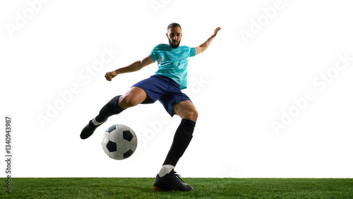 Forward view football player striking ball with full power, showing intensity in expression, precise control on grassy playground. Concept of professional sport, championship, match, victory.