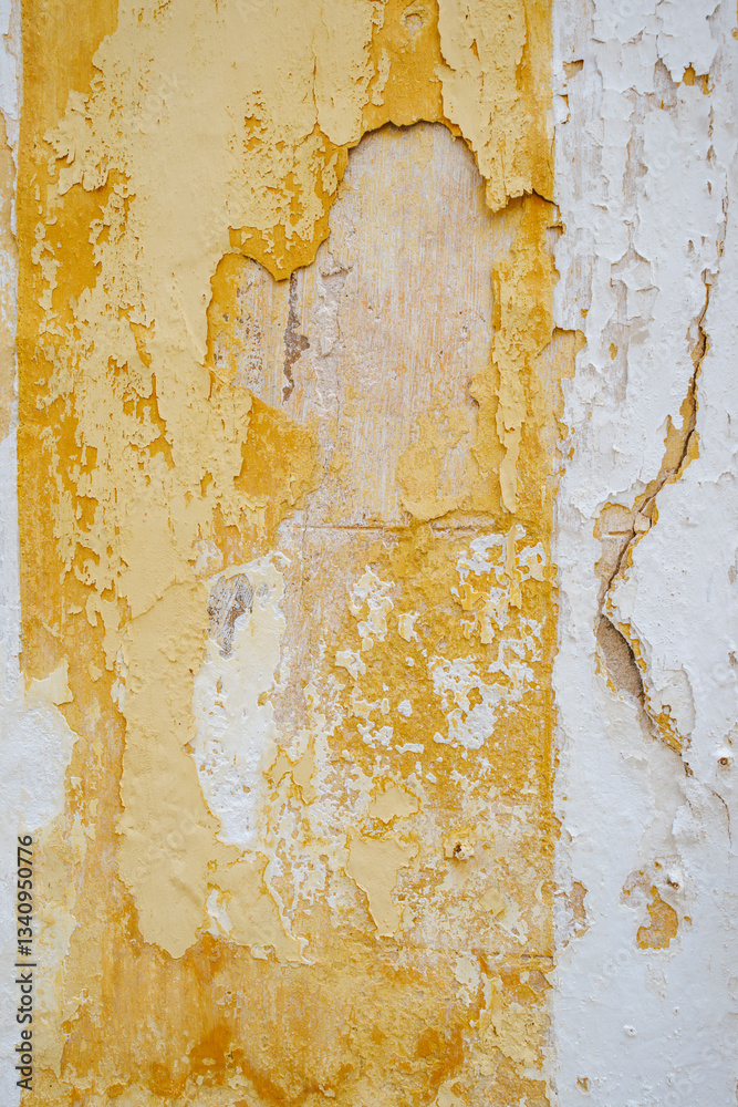 A detailed closeup of a wall with peeling paint in yellow and white tones, capturing the beauty of aged and abstract textures. Ideal for backgrounds, graphic designs, and wall art