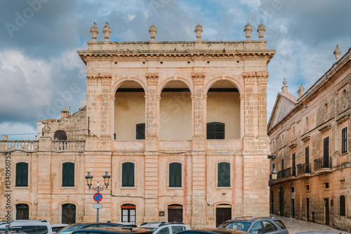 Capture the grandeur of Palace Torresaura in Ciutadella, Menorca. This architectural gem features a historic facade, arched windows, and Balearic elegance. Travel, culture, architecture themes