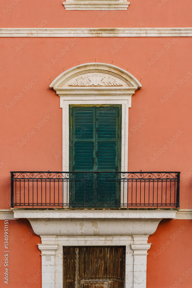 Capture the architectural beauty of Ciutadella with this terracotta facade, featuring green shutters, balconies, and classic design. Ideal for architectural, travel, and cultural themes. Minorca