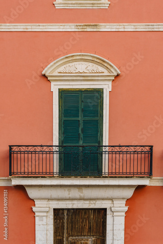 Obraz na płótnie Capture the architectural beauty of Ciutadella with this terracotta facade, featuring green shutters, balconies, and classic design. Ideal for architectural, travel, and cultural themes. Minorca w salonie