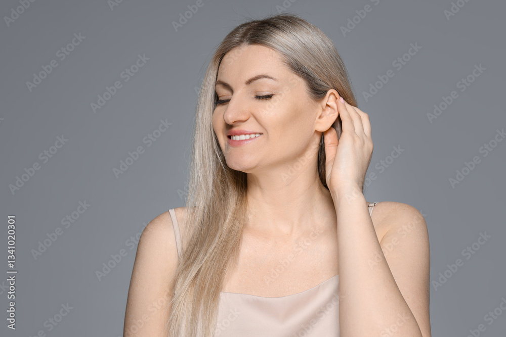 Portrait of beautiful woman on grey background Portrait of beautiful woman on grey background