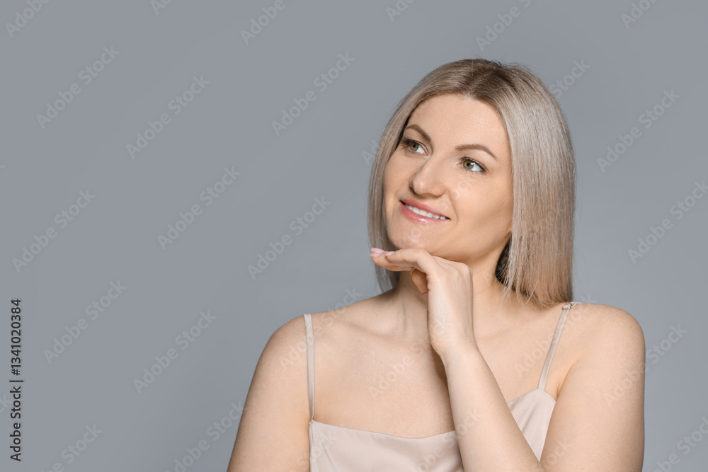 Portrait of beautiful woman on grey background. Space for text Portrait of beautiful woman on grey background. Space for text