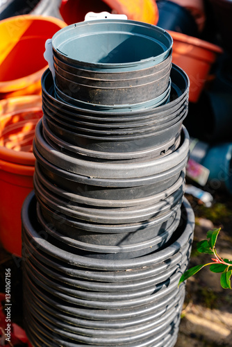 Stack of Plastic Plant Pots in Garden Scene