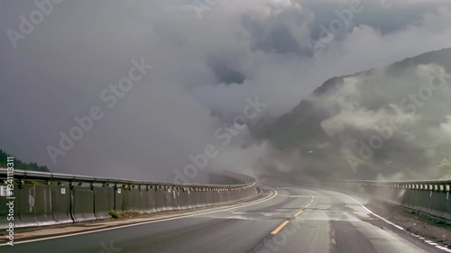 Misty Mountain Road: Fog Rolling Over a Curved Highway