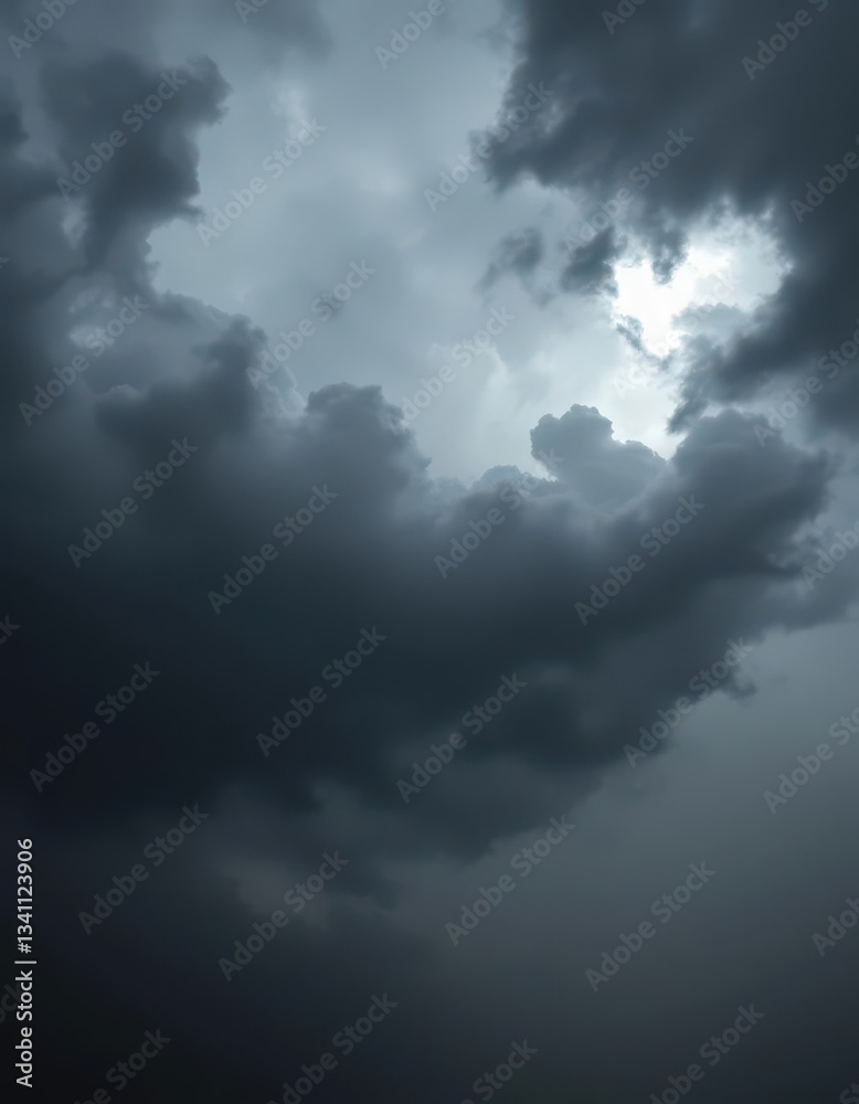 Obraz premium Ominous, brooding storm clouds; dark grey, charcoal, silver linings, heavy rain, atmospheric, moody, dramatic sky, dark grey, intense, silver lining