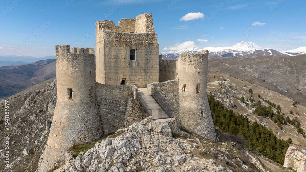 Aerial view of the castle of Rocca Calascio. It is a fortress located in the municipality of Calascio, in Abruzzo, Italy. In the background is the Gran Sasso mountain range with snow-capped peaks. Aerial view of the castle of Rocca Calascio. It is a fortress located in the municipality of Calascio, in Abruzzo, Italy. In the background is the Gran Sasso mountain range with snow-capped peaks.