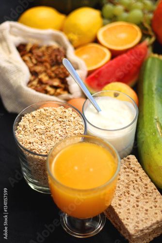 Various healthy fruits, vegetables and cereals on dark background. Selective focus.