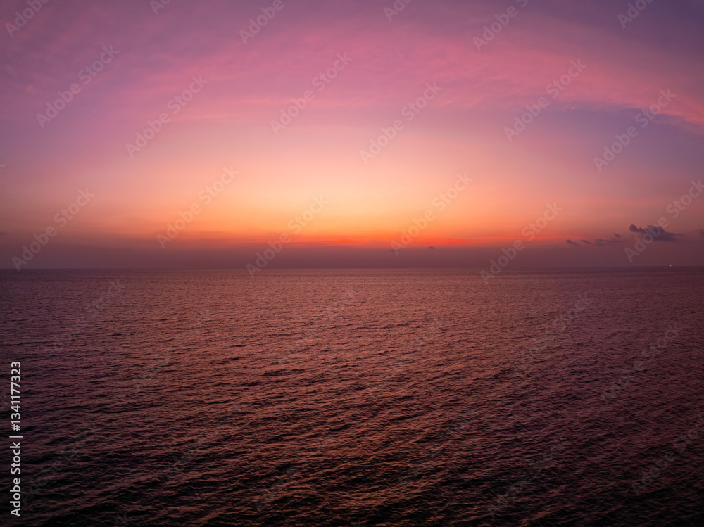 Naklejka premium Colorful sunset or sunrise sky clouds over sea, Amazing nature landscape seascape,Beautiful light nature landscape colorful sky background,High angle view drone shot