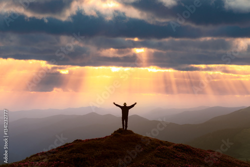 Photography A traveler standing atop a rhododendron-covered mountain peak, admiring a breath