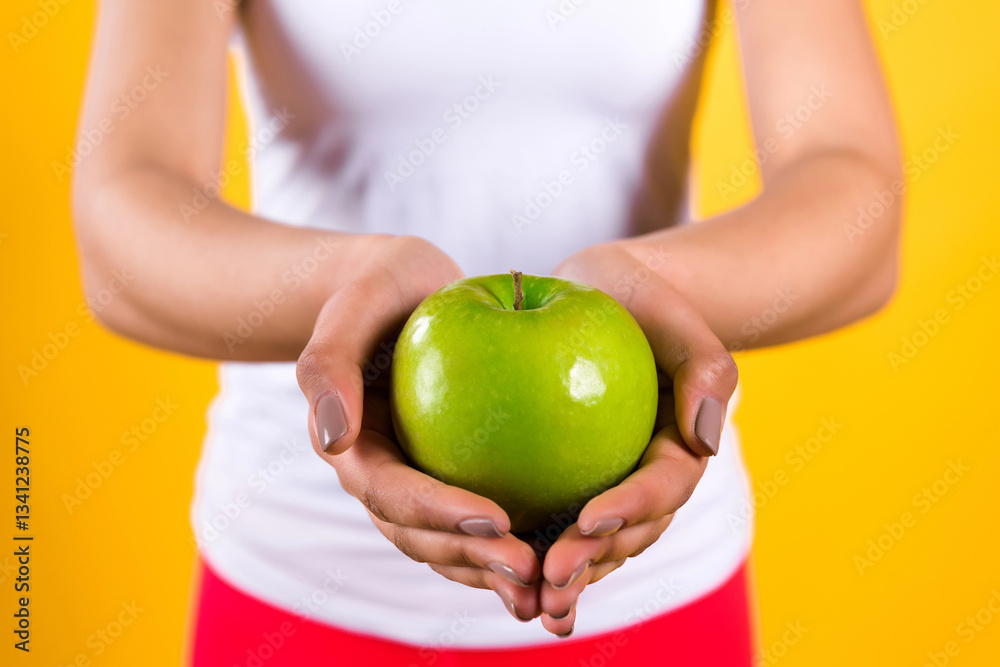 Close up black girl holding apple isolated. Close up black girl holding apple isolated.