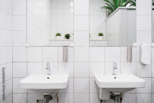 White colour ceramic tiles toilet hand wash area. White colour theme toilet interior. Cleanliness concept. Clean toilet concept.