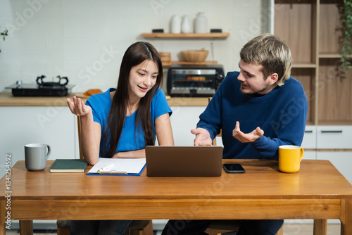 Lifestyle people, using computer working online, doing searching, sitting in the kitchen.