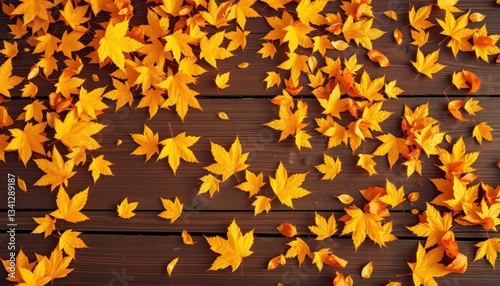 Golden autumn leaves scattered on rich brown wood, warm lighting, warm, fallcolors photo