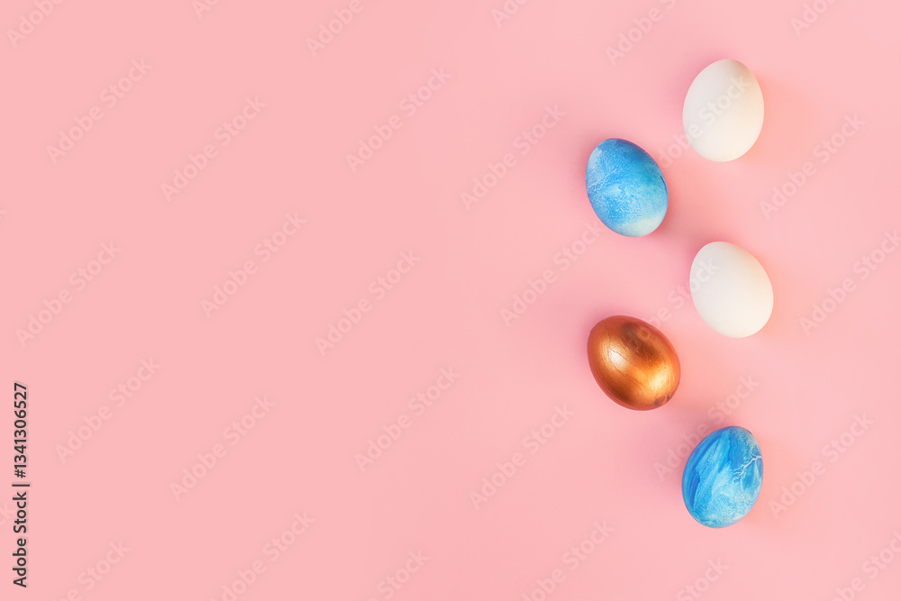 Frame of Easter colorful blue golden and white color eggs on pastel pink background. Stylish trendy gold chocolate egg set isolated. Flat lay, top view, place for text. Happy egg hunt for kids concept Frame of Easter colorful blue golden and white color eggs on pastel pink background. Stylish trendy gold chocolate egg set isolated. Flat lay, top view, place for text. Happy egg hunt for kids concept