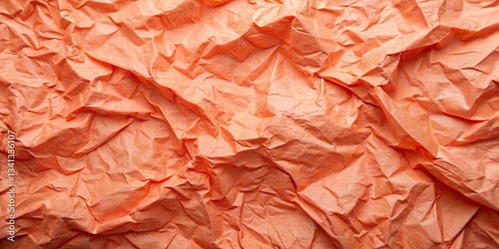 Fototapeta premium Textured coral craft paper: a trendy, crumpled flat lay background.