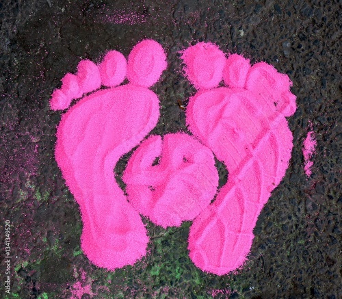 Pink footprints of children's feet on the asphalt. Spring festival Holi. India. 2024.