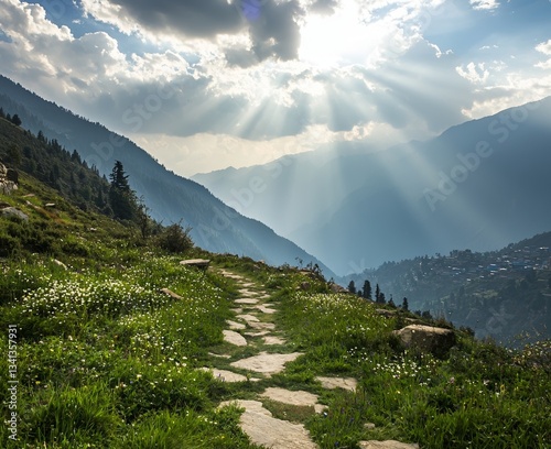 Nepal's mountain valley is home to a breathtaking stone trail that winds through a landscape of green grass, forested hills, and a vibrant blue sky with clouds and sunlight at sunset in the spring
