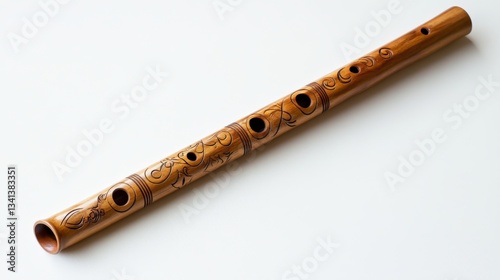 Ornate bamboo flute with carved designs, isolated on white.
