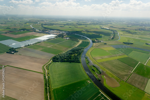 Stunning aerial view of Buitengebied's lush green fields and winding rivers captured during a clear sunny day