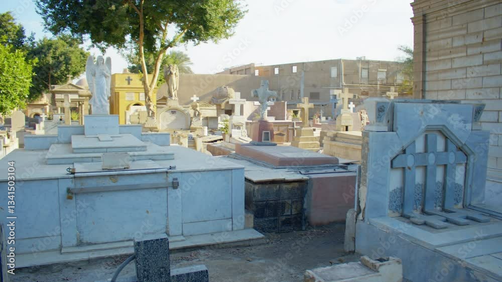 A bright cemetery filled with mausoleums, tombstones, and statues under ...