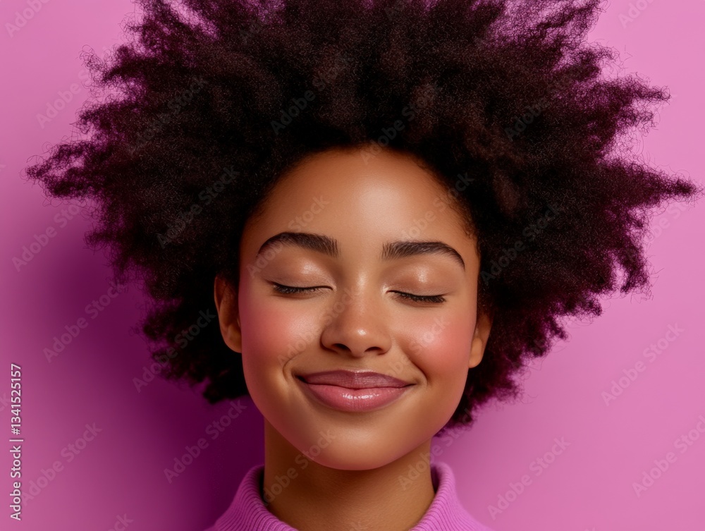Fototapeta premium Portrait of a young woman with bright afro hair in a peaceful and relaxed state of mind while glowing light effects surround her to express emotional tranquility