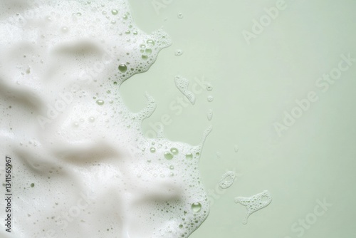 Beauty Product Foam Soap. Abstract background white soapy foam flowing texture. Shampoo foam with bubbles. Bubble surface isolated on pastel mute mint green color. Suds. Facial cleanser. Froth Pattern photo