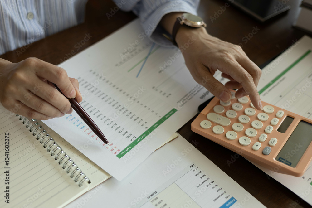 the businessman is sitting at a desk with a calculator and a stack of papers. She is looking at the papers and seems to be deep in thought
the businessman is sitting at a desk with a calculator and a stack of papers. She is looking at the papers and seems to be deep in thought