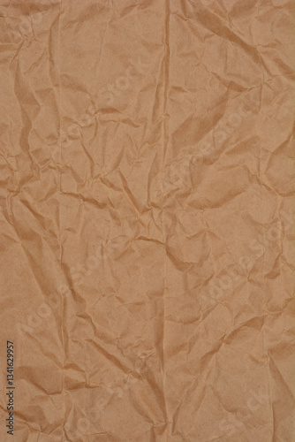 A close-up shot of crumpled kraft paper, showcasing its texture and neutral brown color
