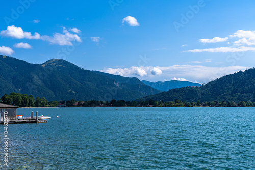 Beautiful panorama view of Tegernsee lake with Bavarian alps in background on a sunny summer day with blue sky cloud, Tegernsee, Bavaria, Germany