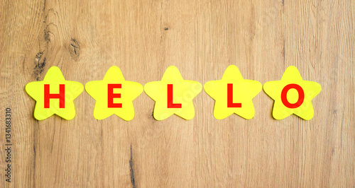 Wallpaper Mural Hello symbol. Concept word Hello on beautiful yellow paper stars. Beautiful wooden table wooden background. Business lifestyle hello concept. Copy space. Torontodigital.ca