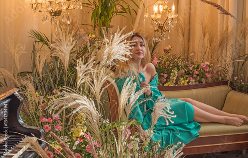 European Slavic woman posing in boho style turquoise dress. Concept of fashion. Hippie style and ethno