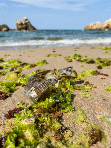 Waste plastic diving goggles that will be brought to the beach by waves. Plastic pollution and environmental problem concept. Recycle reduce and reuse