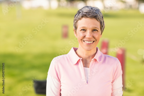 Smiling woman enjoying morning walk in park, feeling refreshed and happy, copy space