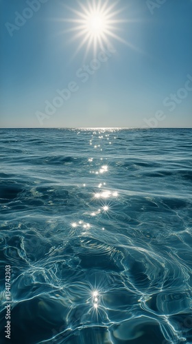 Bright Sunlight Reflects off Calm Ocean Waves Under a Clear Sky