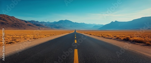 Endless Road Stretches Through Desert Landscape Under Clear Blue Sky in Brigh...