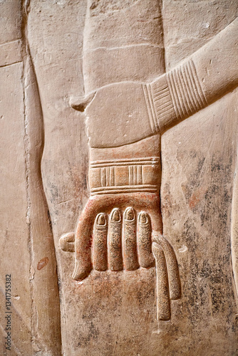 Woman holding man's hand in sign of affection form the wall of Mereruka tomb, Saqqara, Egypt photo