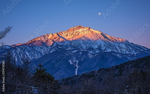 Snowy mountain peak at sunrise, tranquil Japanese landscape, moon visible