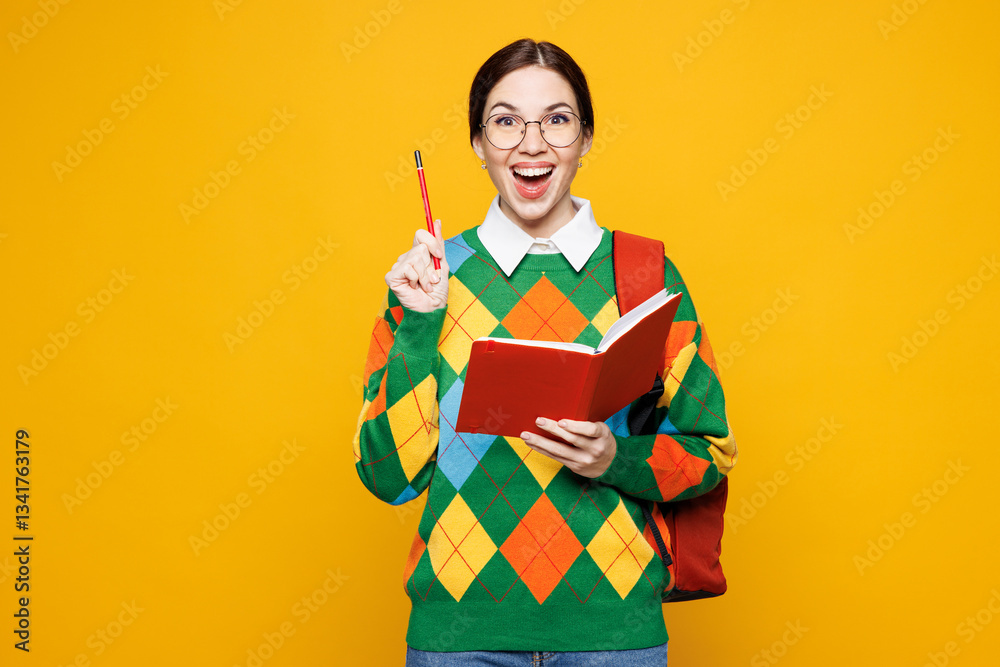 Young surprised girl student she wears green casual clothes backpack bag hold book write down in notebook isolated on plain yellow background studio portrait. High school university college concept.