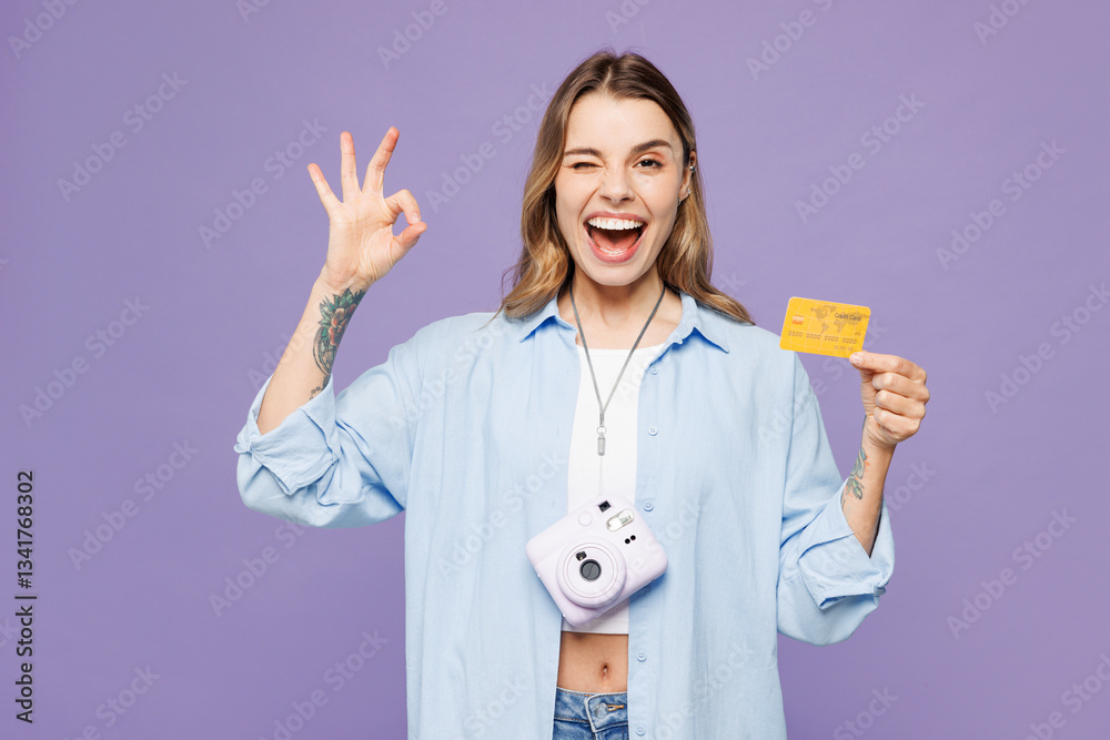 Traveler woman wear blue clothes hold credit bank card show ok okay gesture isolated on plain purple background. Tourist travel abroad in free spare time rest getaway. Air flight trip journey concept. Traveler woman wear blue clothes hold credit bank card show ok okay gesture isolated on plain purple background. Tourist travel abroad in free spare time rest getaway. Air flight trip journey concept.