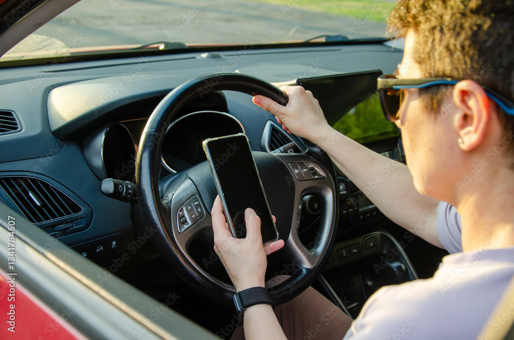 Naklejka premium woman Driver Using Smartphone While Steering the Car