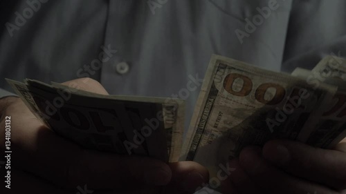 Men's hands counting paper bills into hundred dollar bills, credit, cash, family budget, capitalism