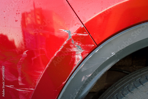 Obraz na płótnie Car’s rear bumper with deep scratches, paint chips, and scuff marks, exterior damage and the necessity for repair and painting services. Car accident aftermath, minor dents and scratches w salonie