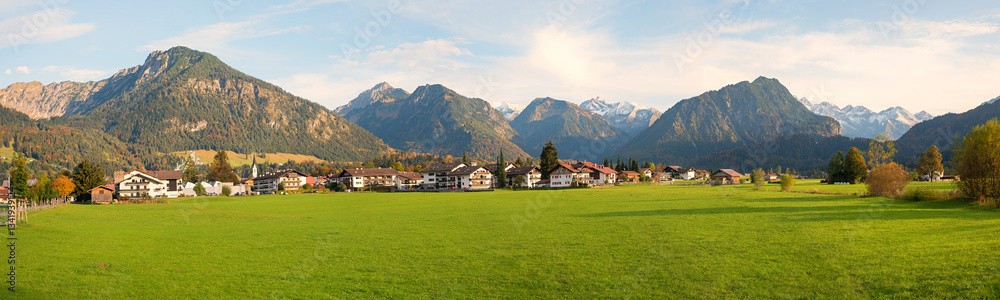 view over green pastures to Oberstdorf tourist resort, allgau alps in autumn