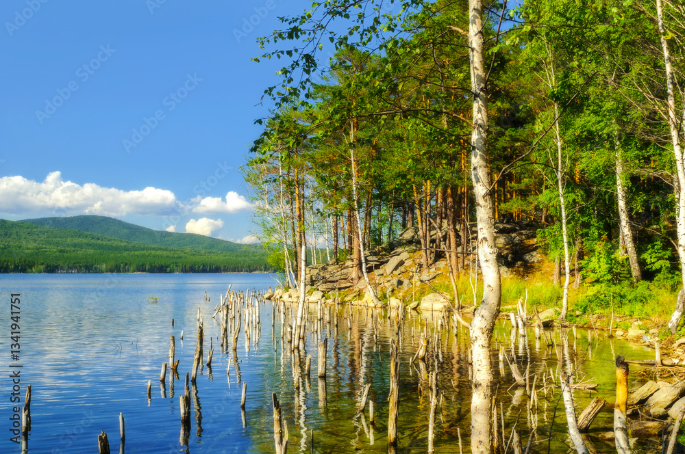 Summer mountain forest landscape - the Turgoyak lake and the coast of the St Faith Island in Southern Urals, summer picturesque view of Russian nature Summer mountain forest landscape - the Turgoyak lake and the coast of the St Faith Island in Southern Urals, summer picturesque view of Russian nature