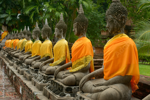 Buddha statues dressed in orange robes at a temple in Chiang Mai