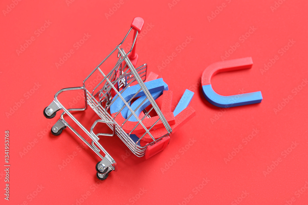 Mini trolley with magnets on red background Mini trolley with magnets on red background