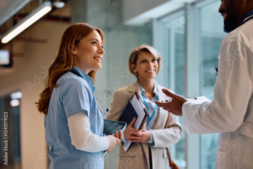 Happy nurse on meeting with hospital administrator and doctor. photo