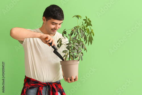 Young man with shovel and p...