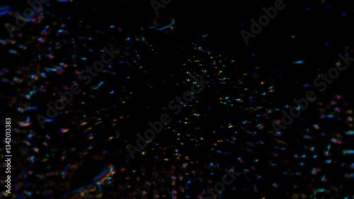 dark abstract background filled with tiny, multicolored particles scattered like stars or digital sparks. The random dispersion and glowing effect create a cosmic or data-driven atmosphere, evoking a 